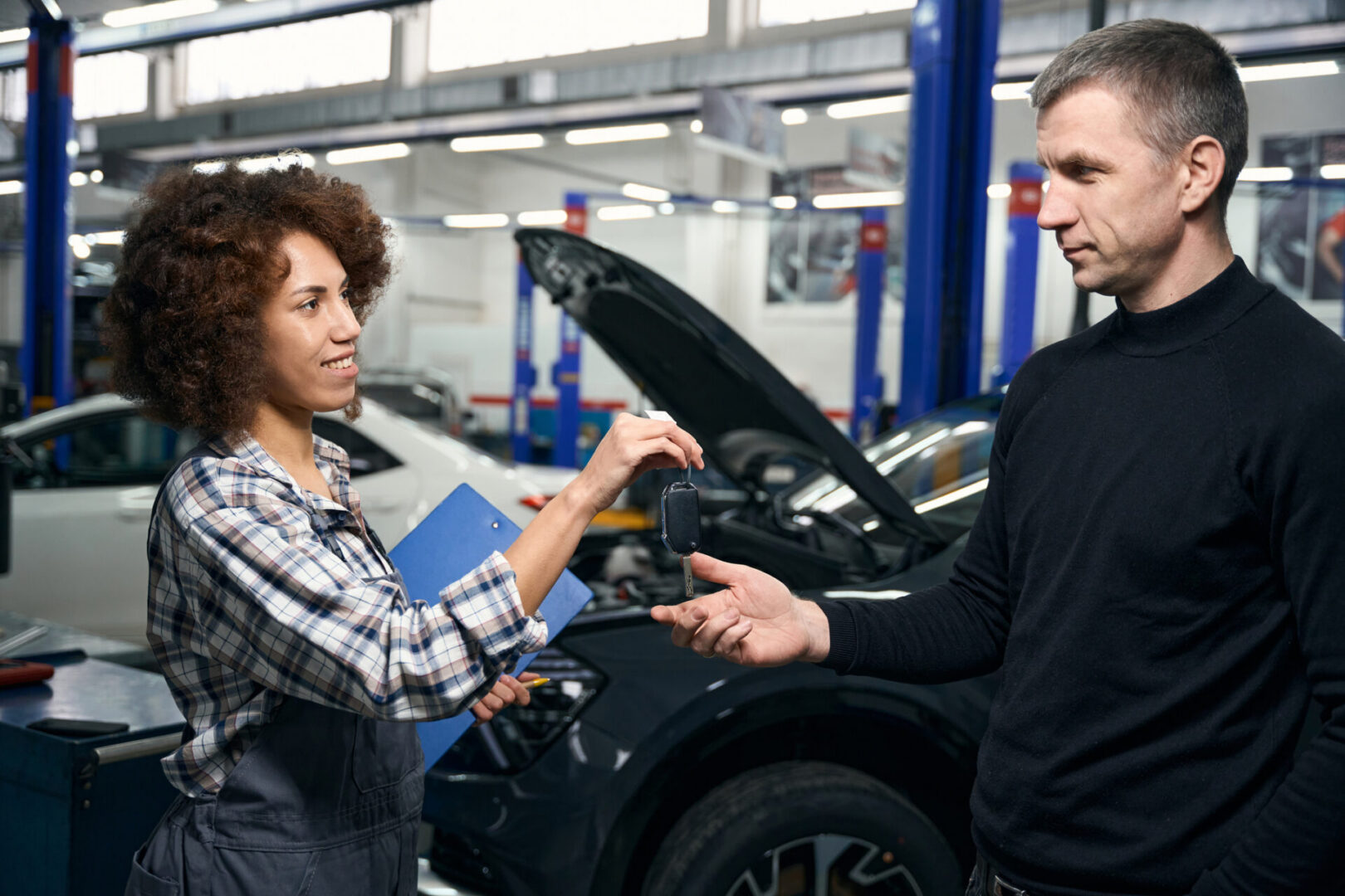 Mechanic handing car keys to customer
