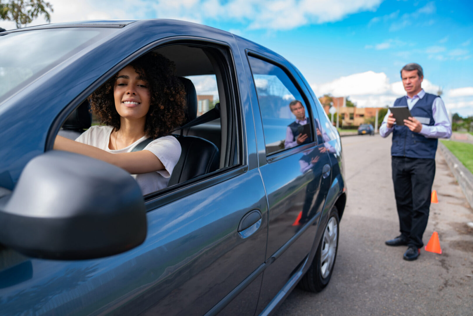 Smiling woman in car during driving test
